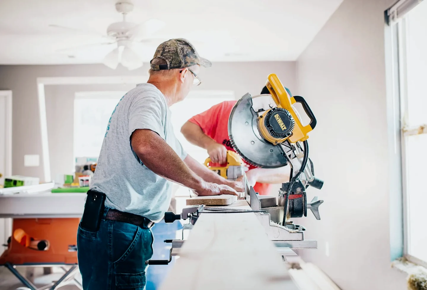 Craftsperson cutting material during an interior build