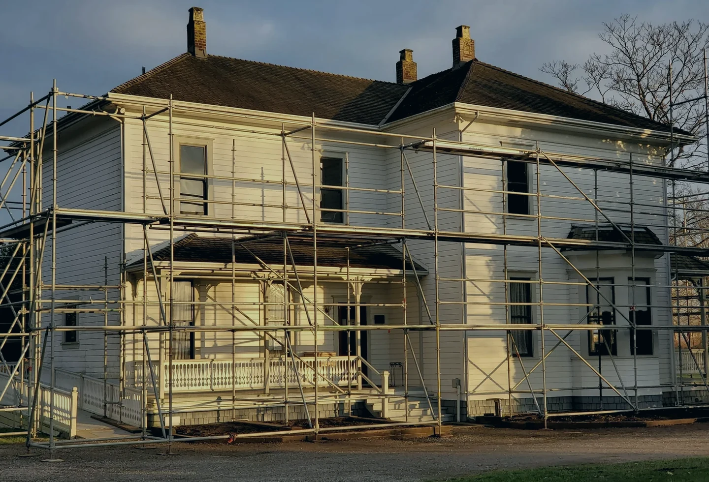 Home exterior under restoration with scaffolding in place