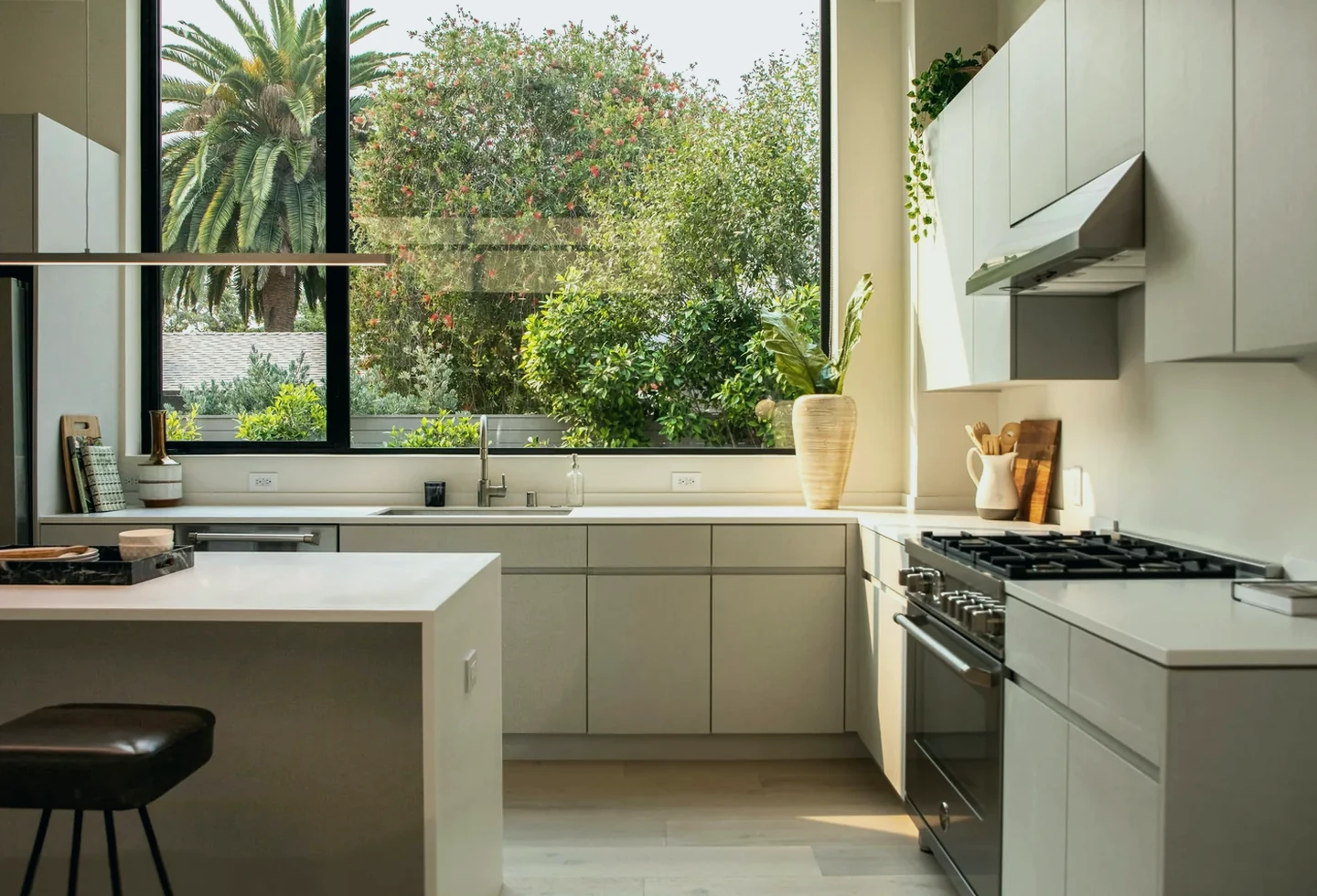 Bright modern kitchen with clean cabinets and large windows